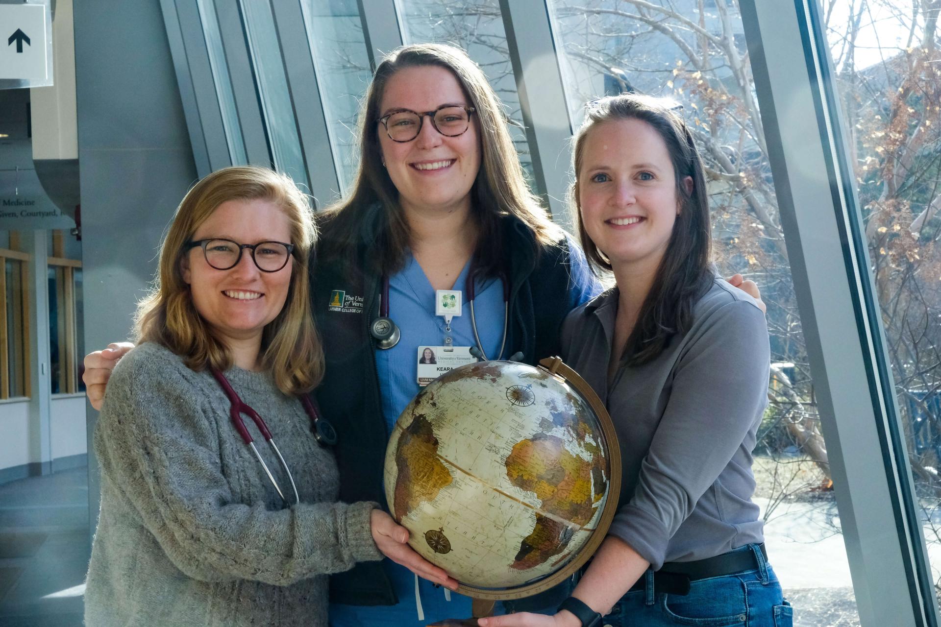 Students participating in the Global Health program posing with a globe.