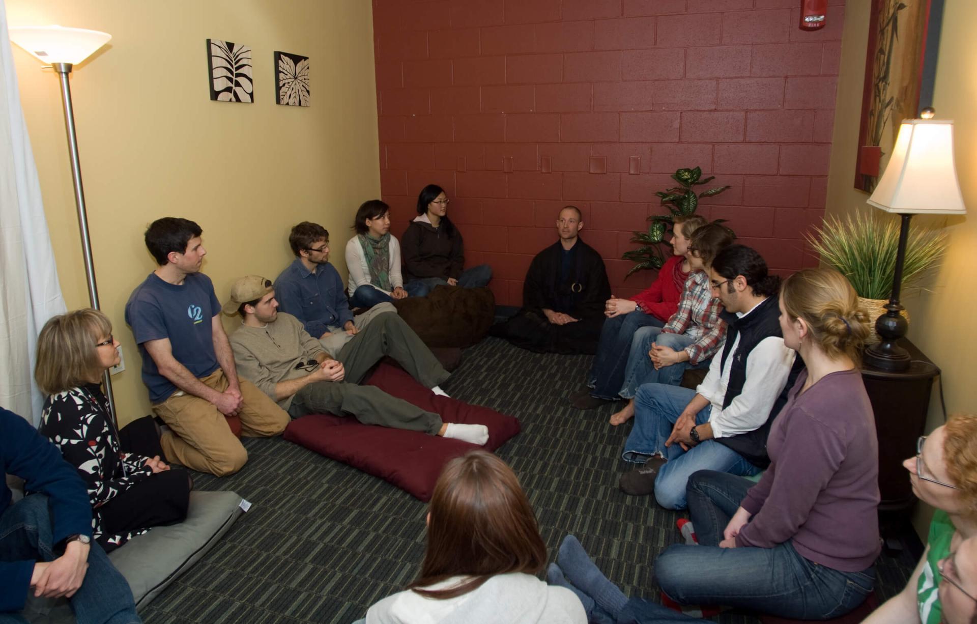 Students sitting in a circle practicing meditation.