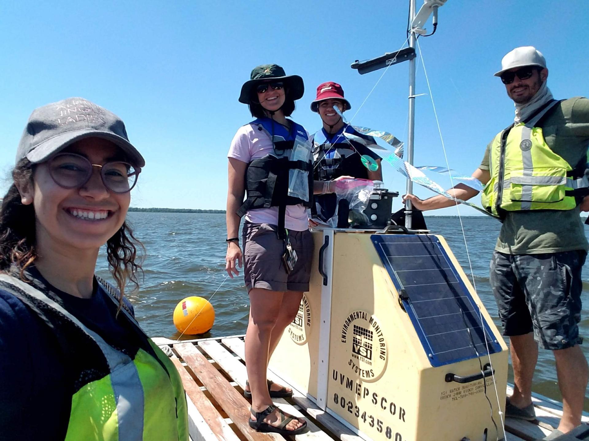 Water researchers installing equipment on Lake Champlain