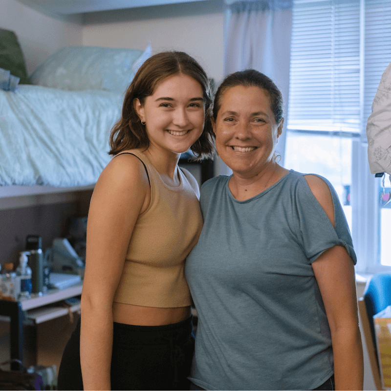 A mother and daughter post together during move-in