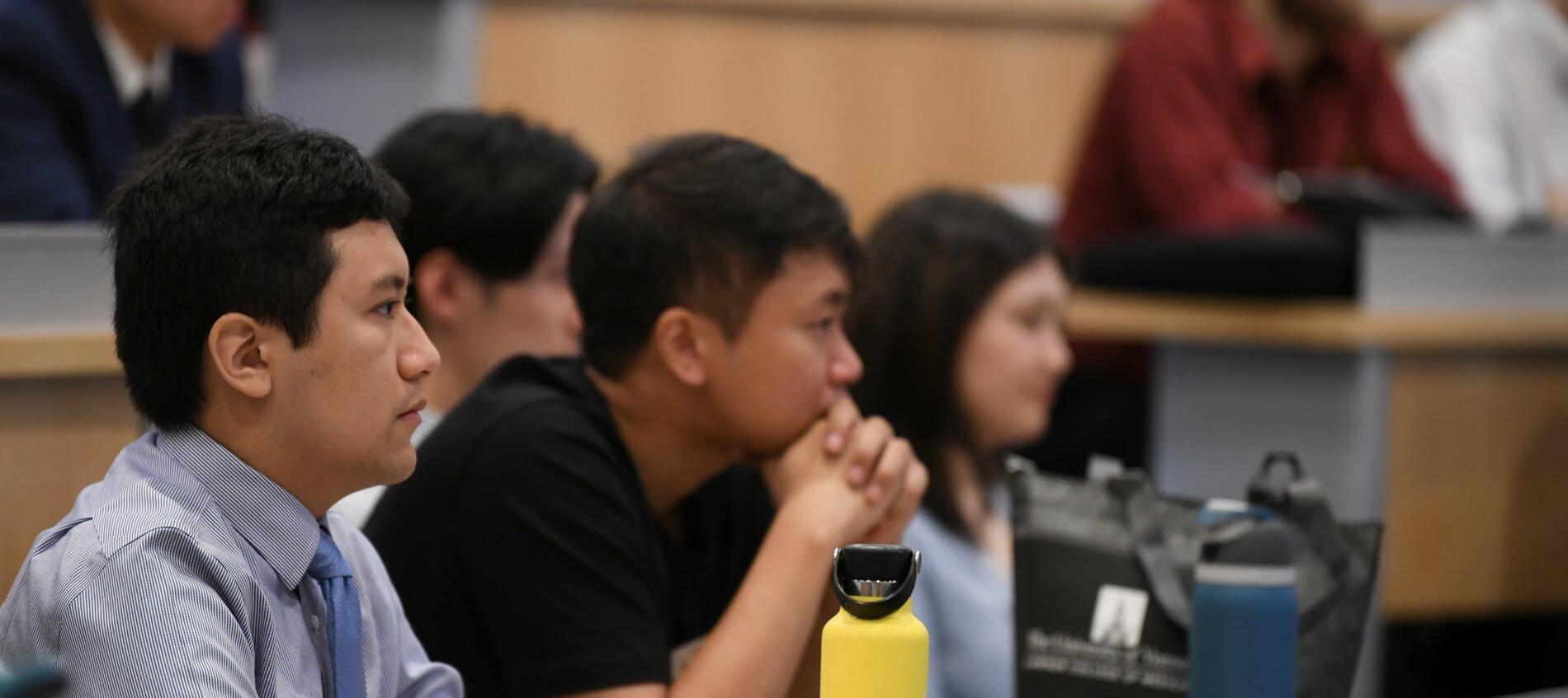 group of students listen intently