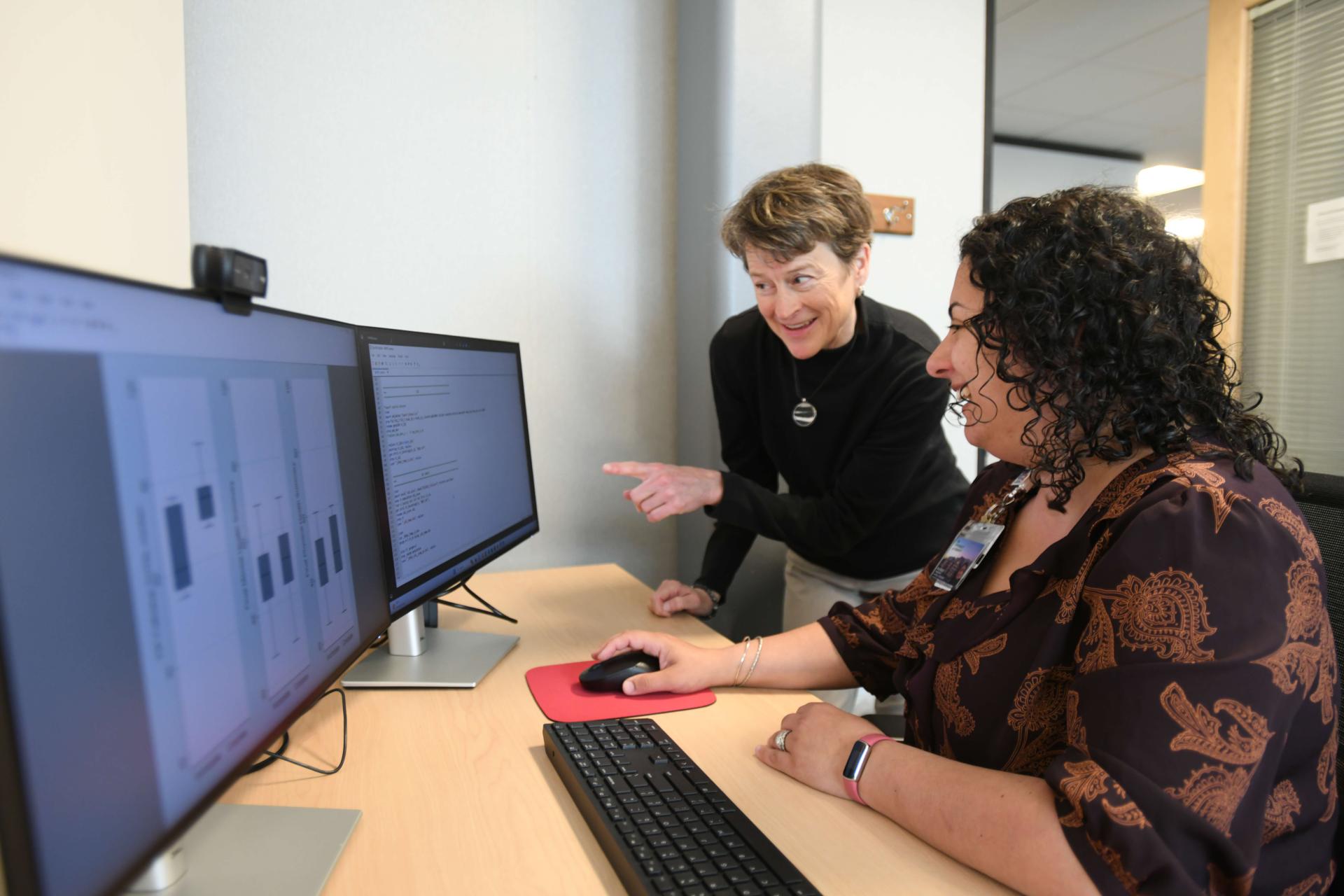 CTS student and professor collaborating at a computer