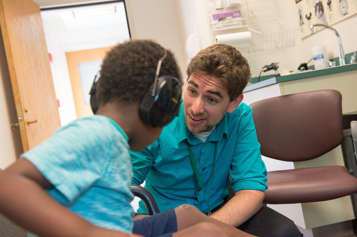 Communication sciences student works with a young patient