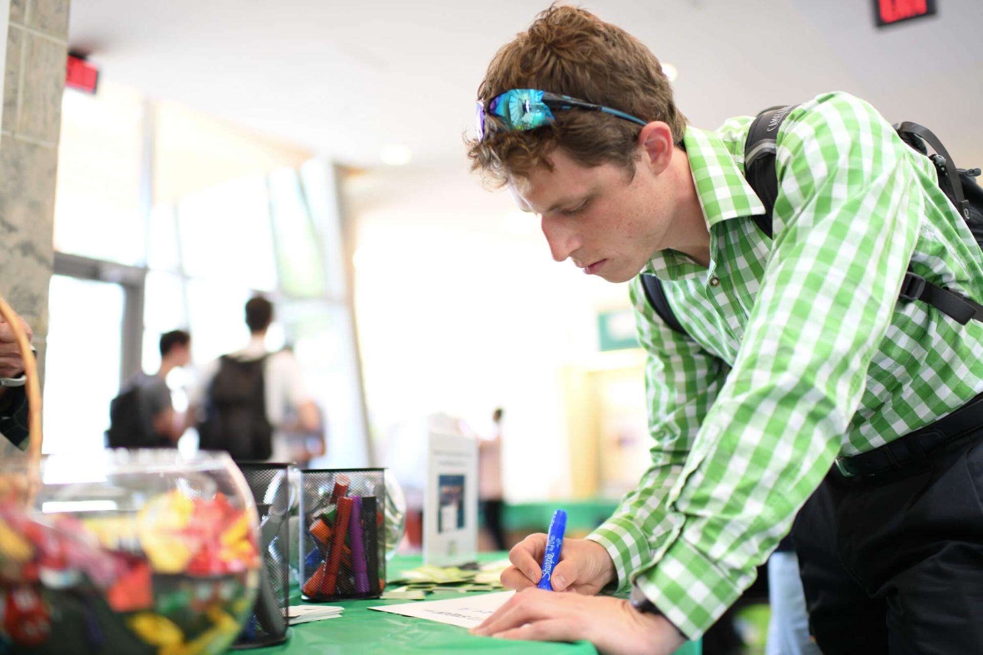 Medical student filling out Financial Aid paperwork at Orientation