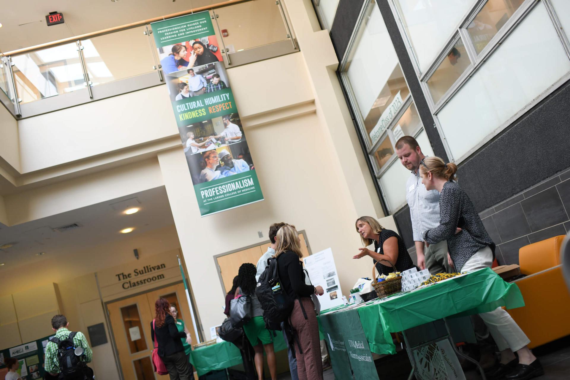 Students speaking to department leaders at orientation 