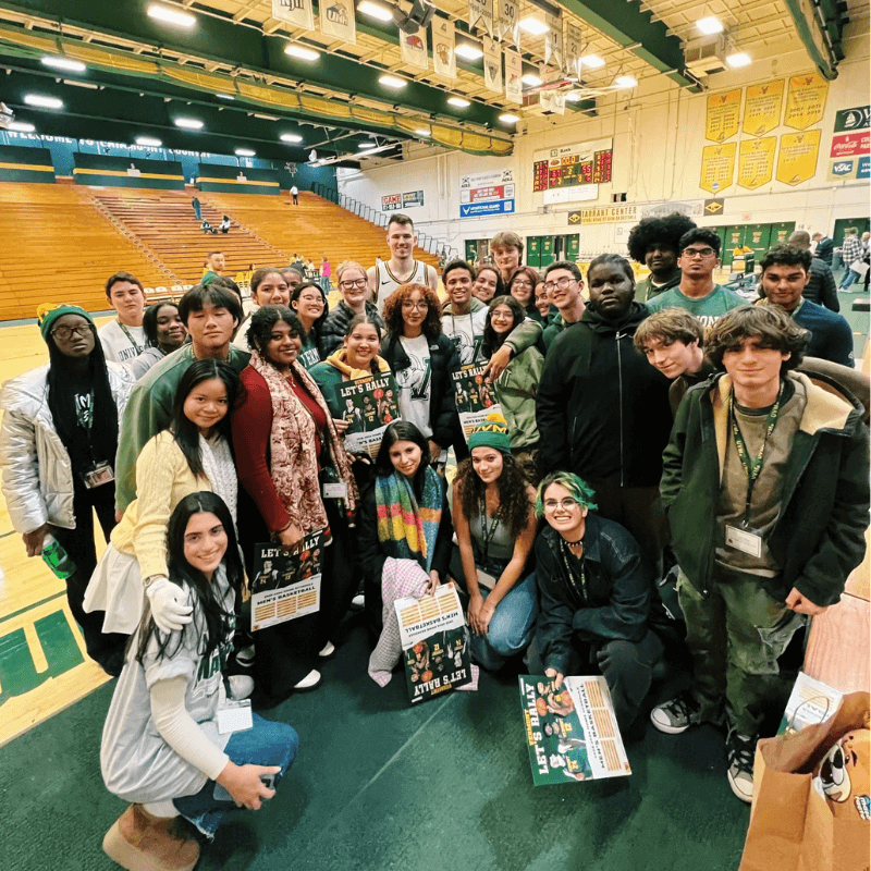 Group of students poses together in the gym