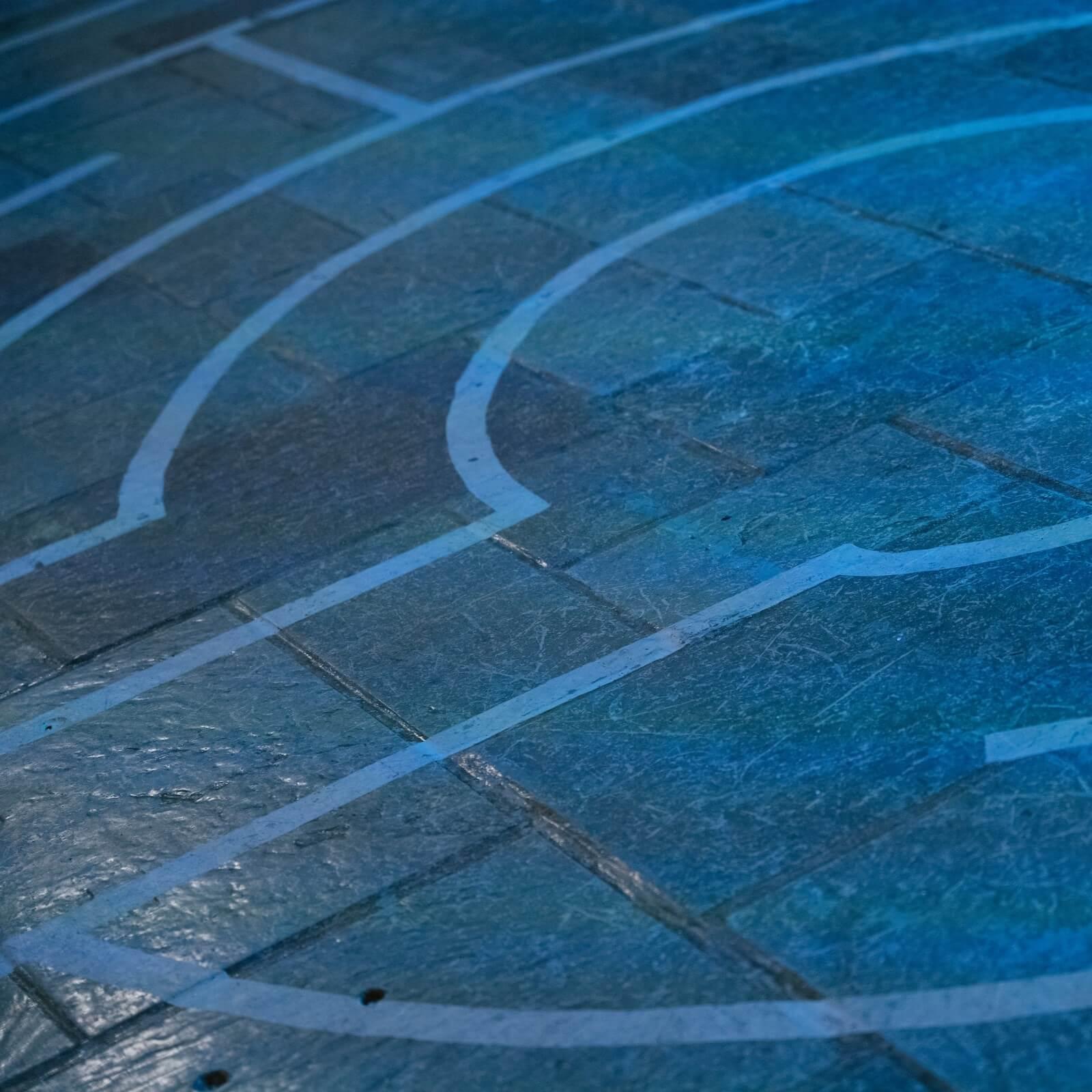 Segment of a labyrinth painted onto a tile floor of the Interfaith Center 