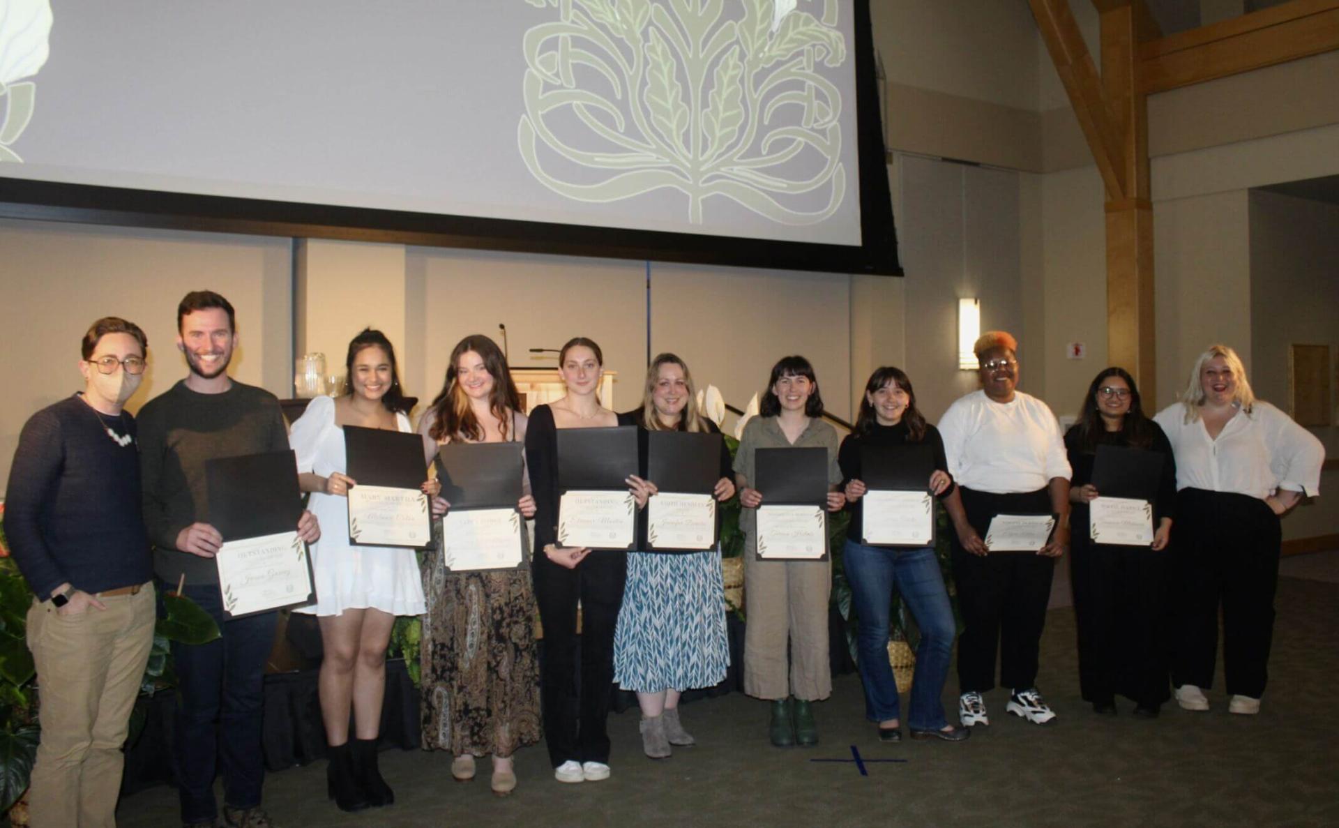 Students holding their certificates at the MARCH event.