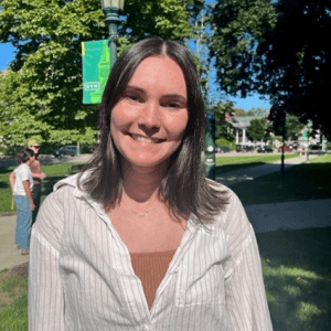 Annabel, smiling while out on a blue-sky day on UVM green