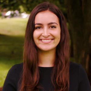 Julia, smiling under a tree