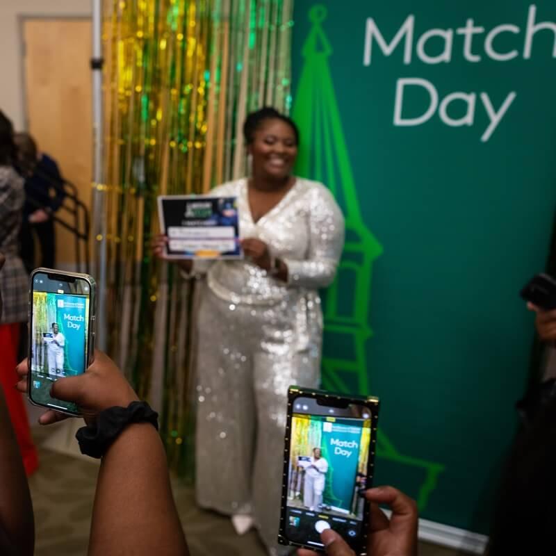 young woman gets her photo taken at match day event