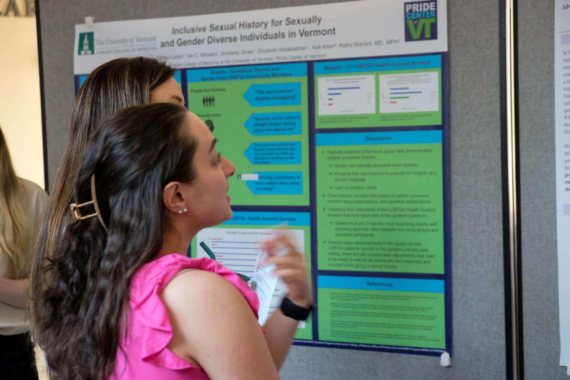 Student presenting research at a poster session.