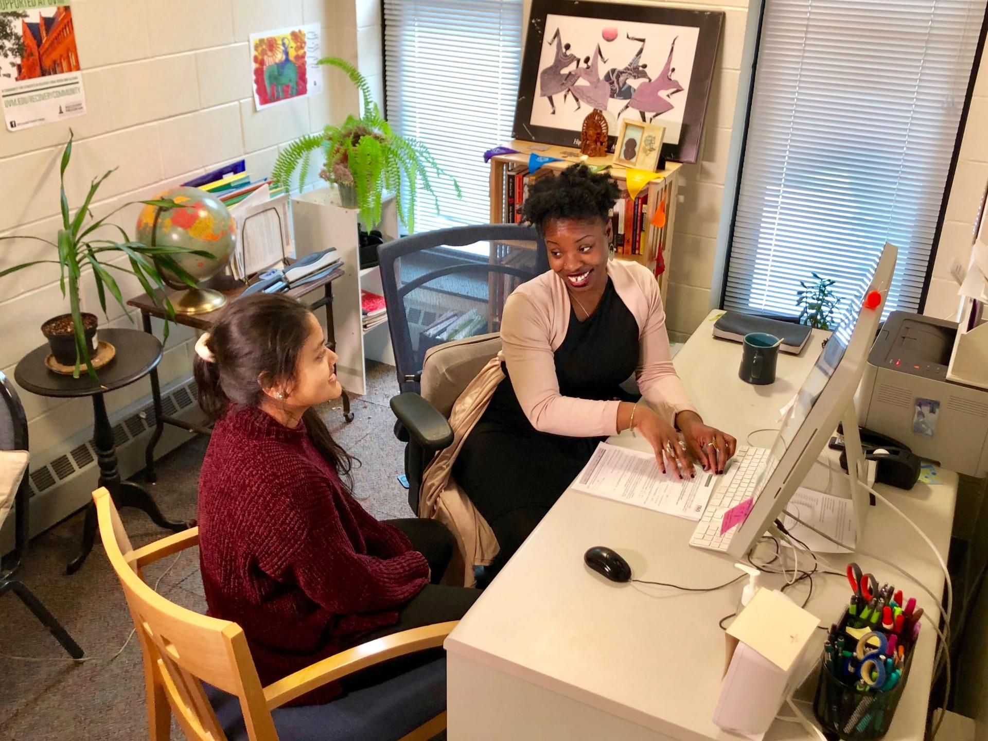 Social work talking with a client in her office.