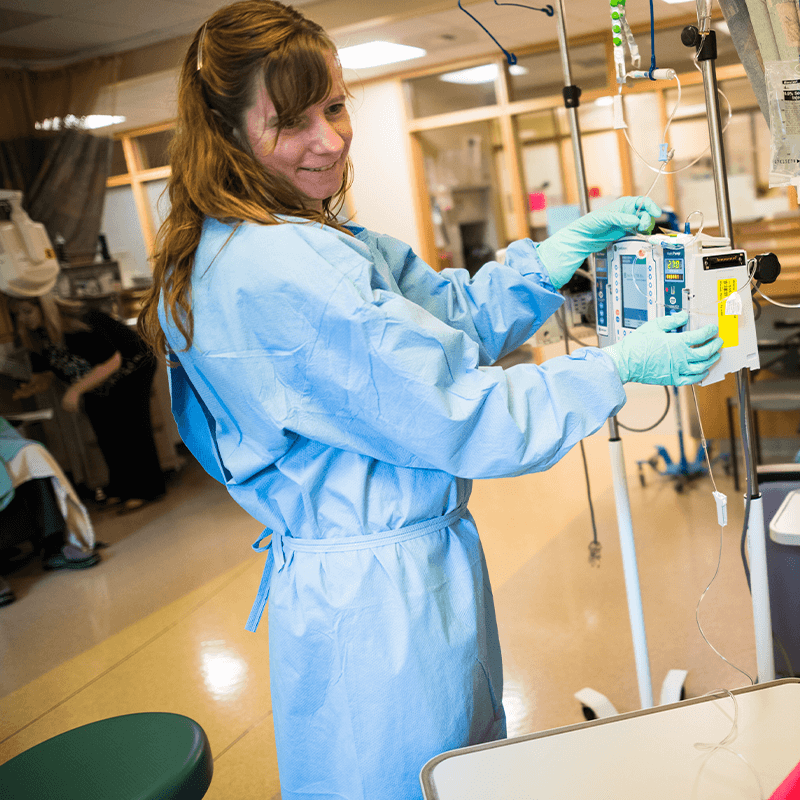 Nurse prepping for a chemotherapy treatment in the infusion area.