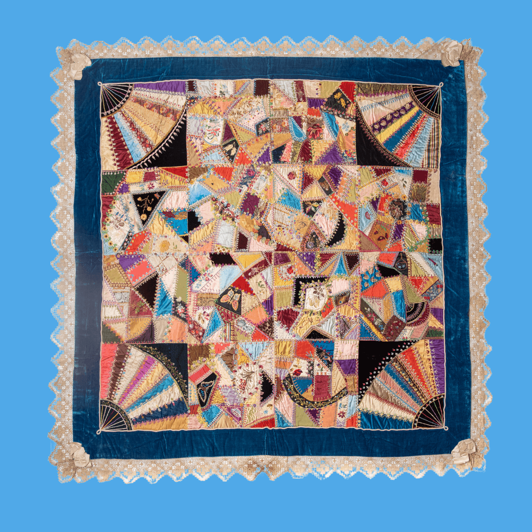 A deep blue border surrounds the bright colors and odd shapes of this "crazy quilt".