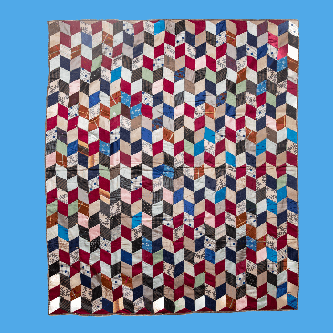 Multi-colored diamond-shaped fabrics make up this stunning quilt.