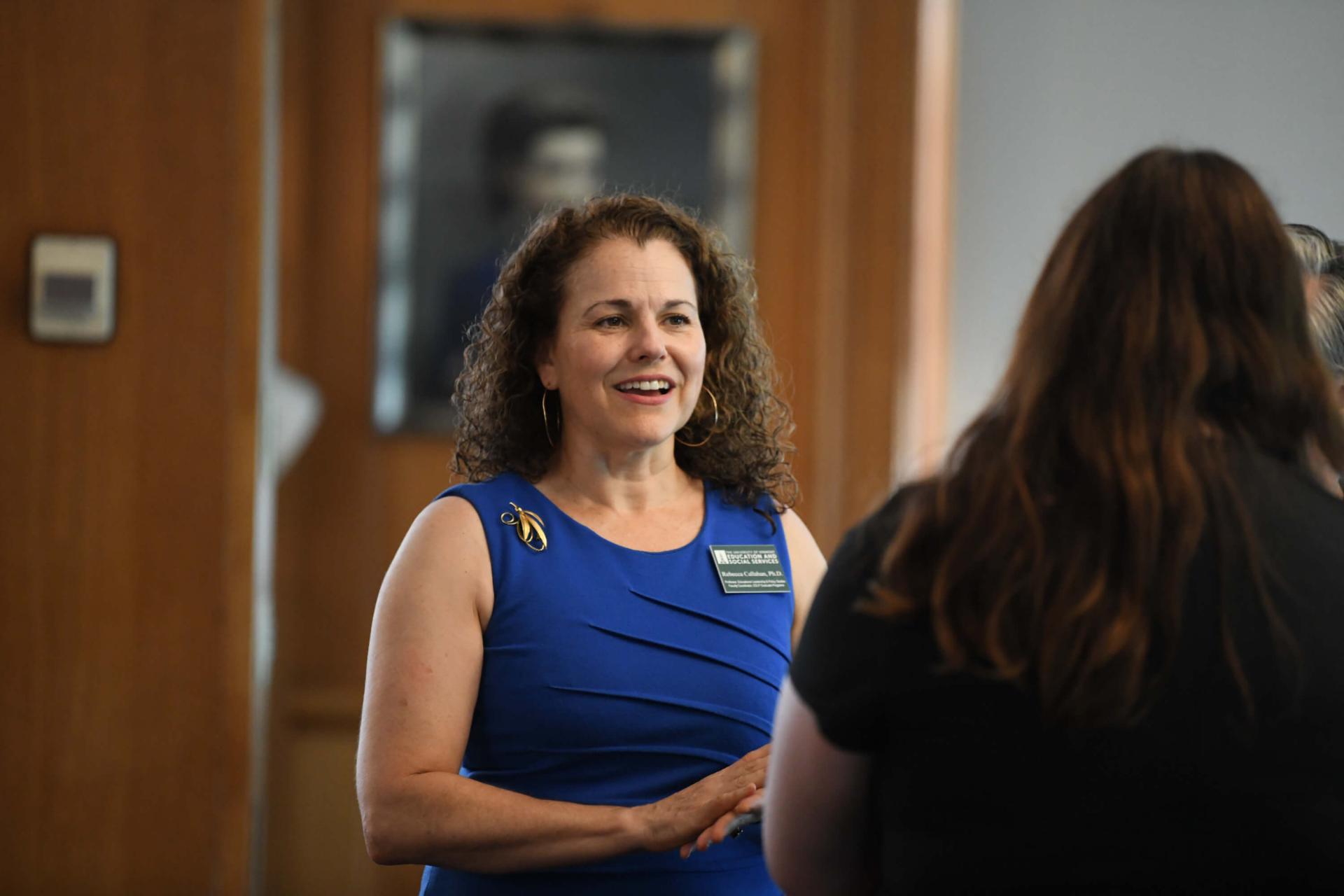 Professor Rebecca Callahan speaks with a doctoral student.