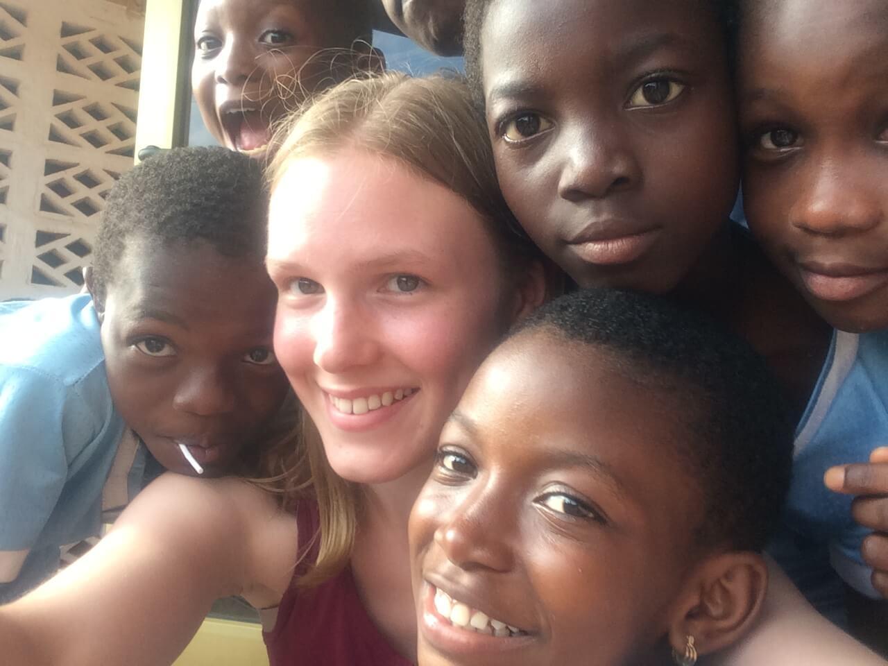 girl surrounded by children