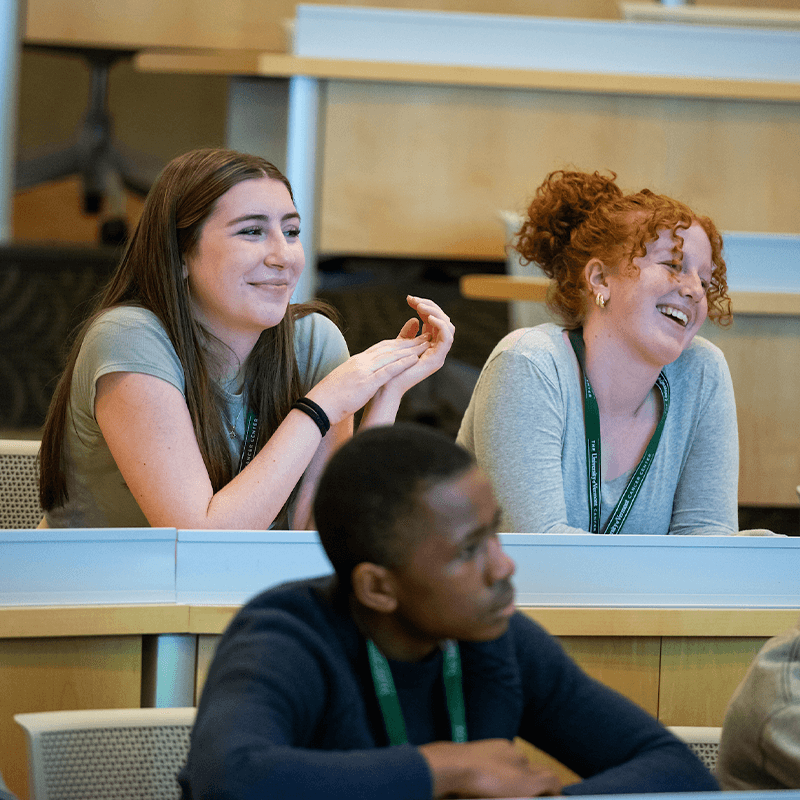 Three high school students in a classroom. 