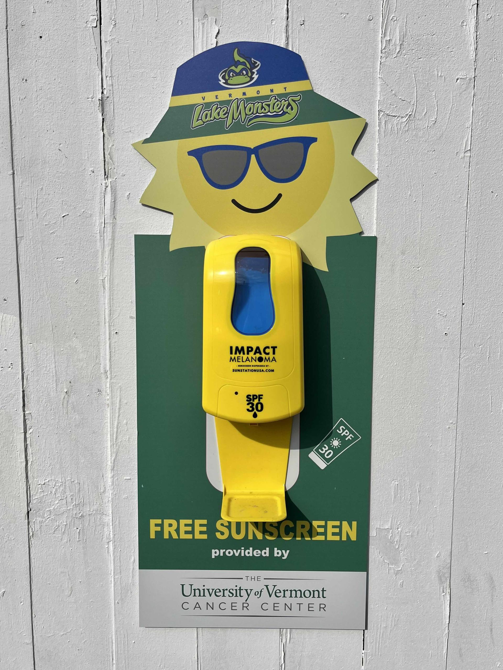 Green and gold sunscreen dispenser. 