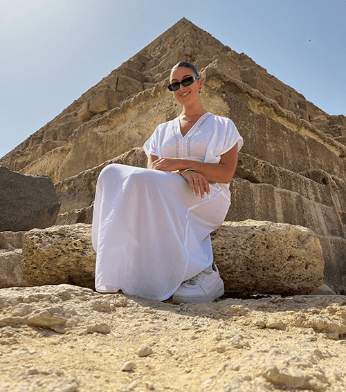 Isabelle seated on the steps of a pyramid in Morroco