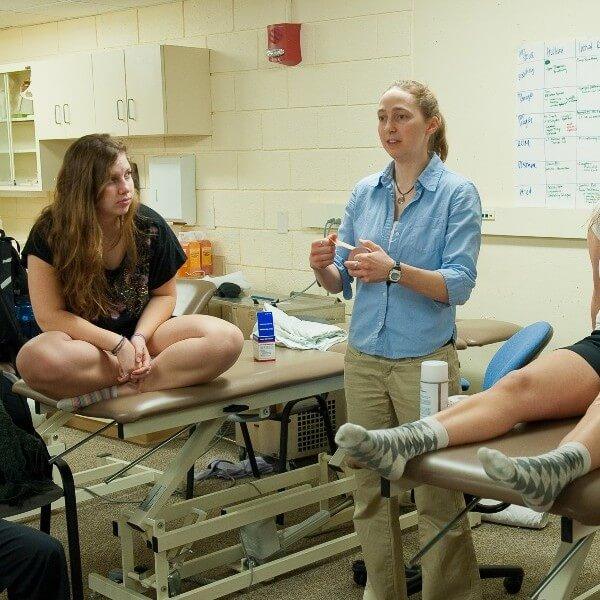 Students listen to professor in exercise lab