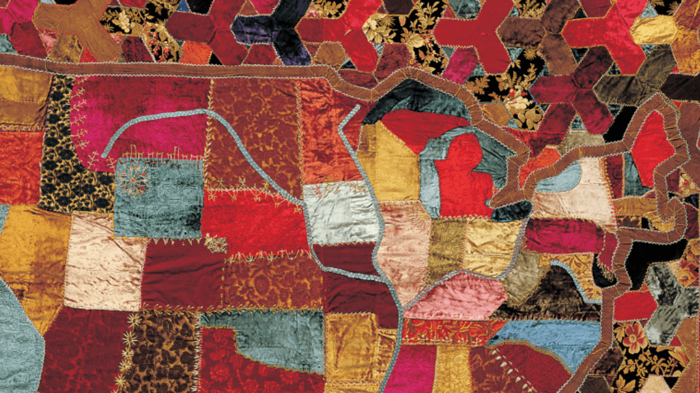 Varying fabric pieces are sewn together, creating a quilt map of the United States.