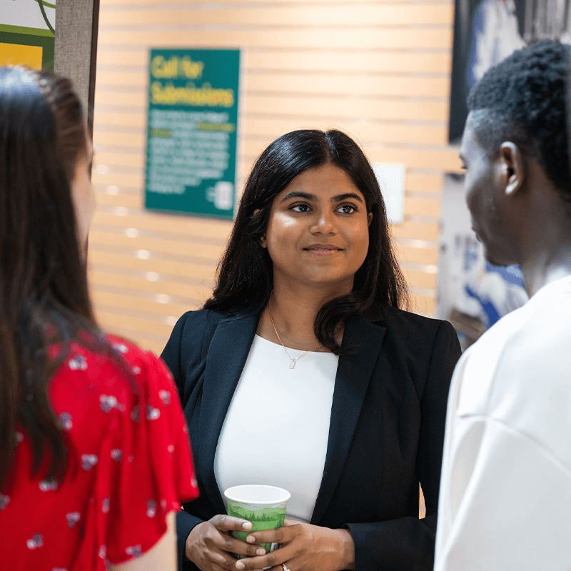 Three students at the summer student research fair. 