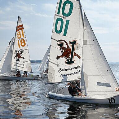 Two UVM sailing boats tack across the lake.