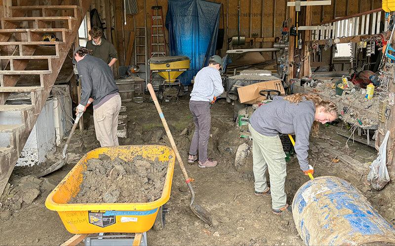 Students in the UVM Engineers Without Borders chapter volunteer to assist with flood cleanup