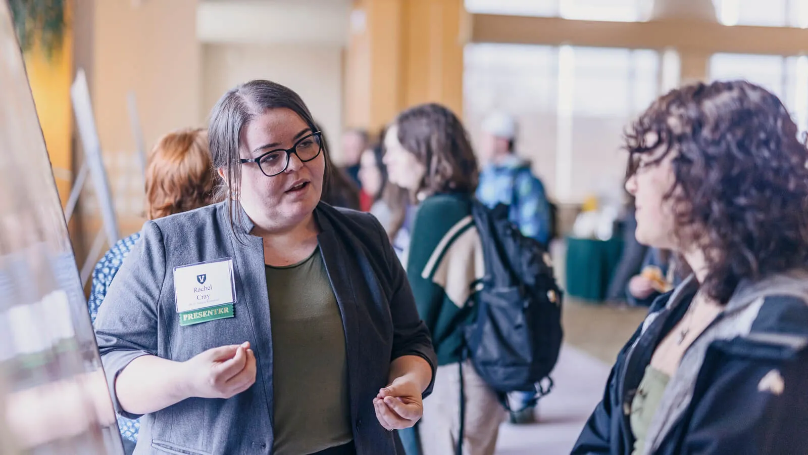 Students discussing their research at a conference