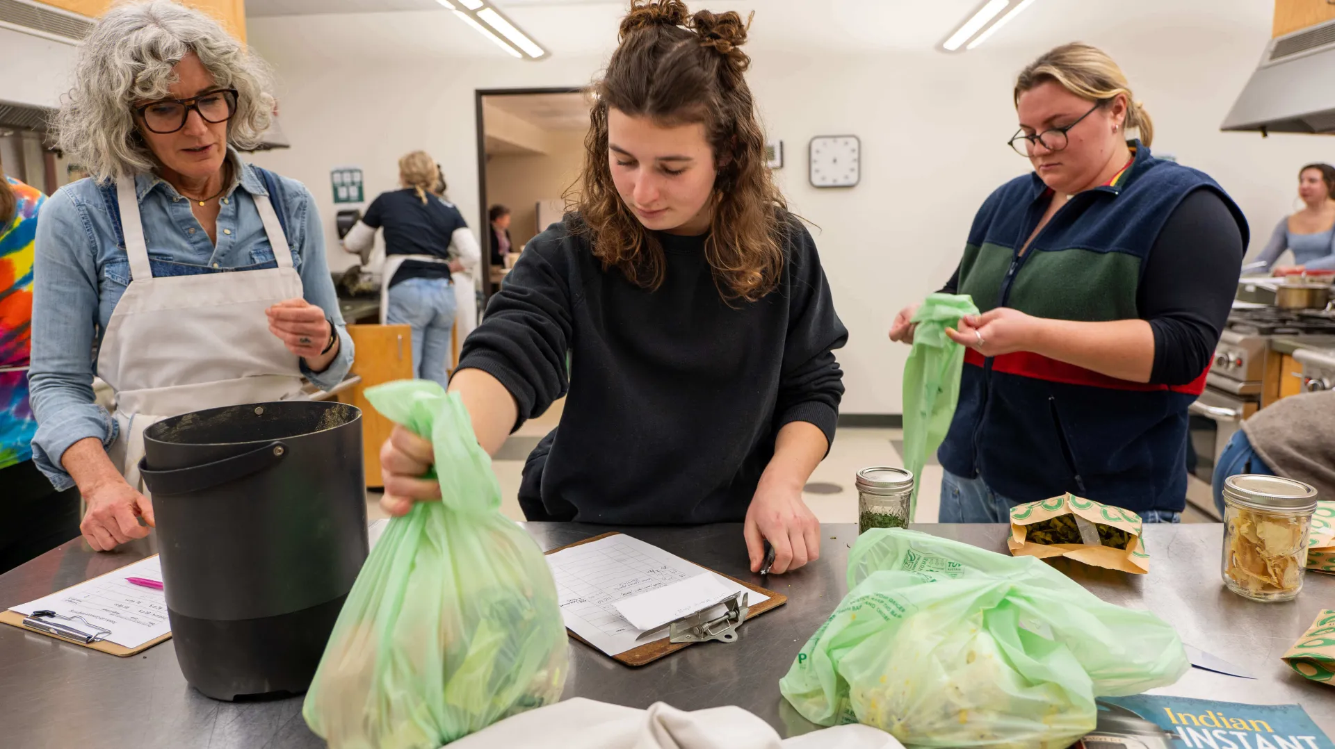 Researchers weighing bags of food waste