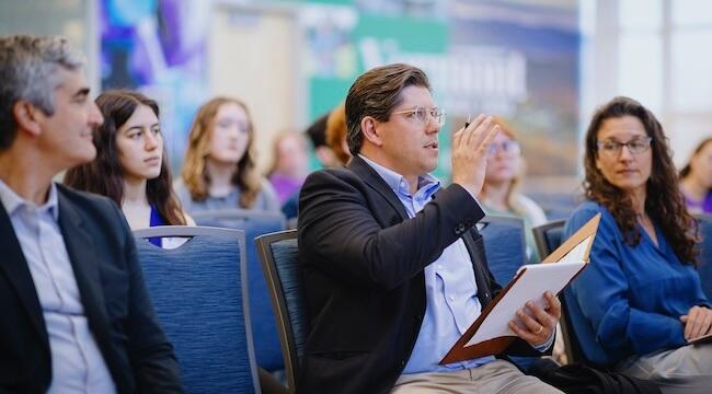 Audience members ask questions of student presentations