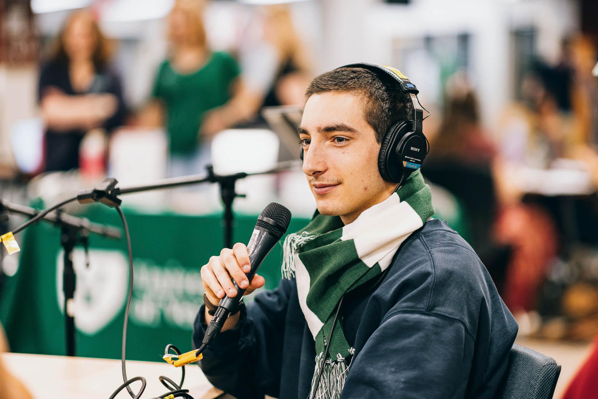 A student uses the UVM Libraries podcasting equipment