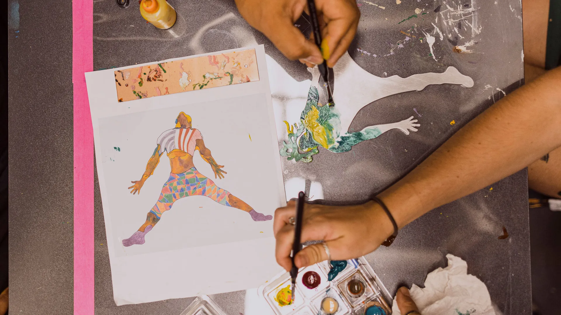 Hands painting on a canvas