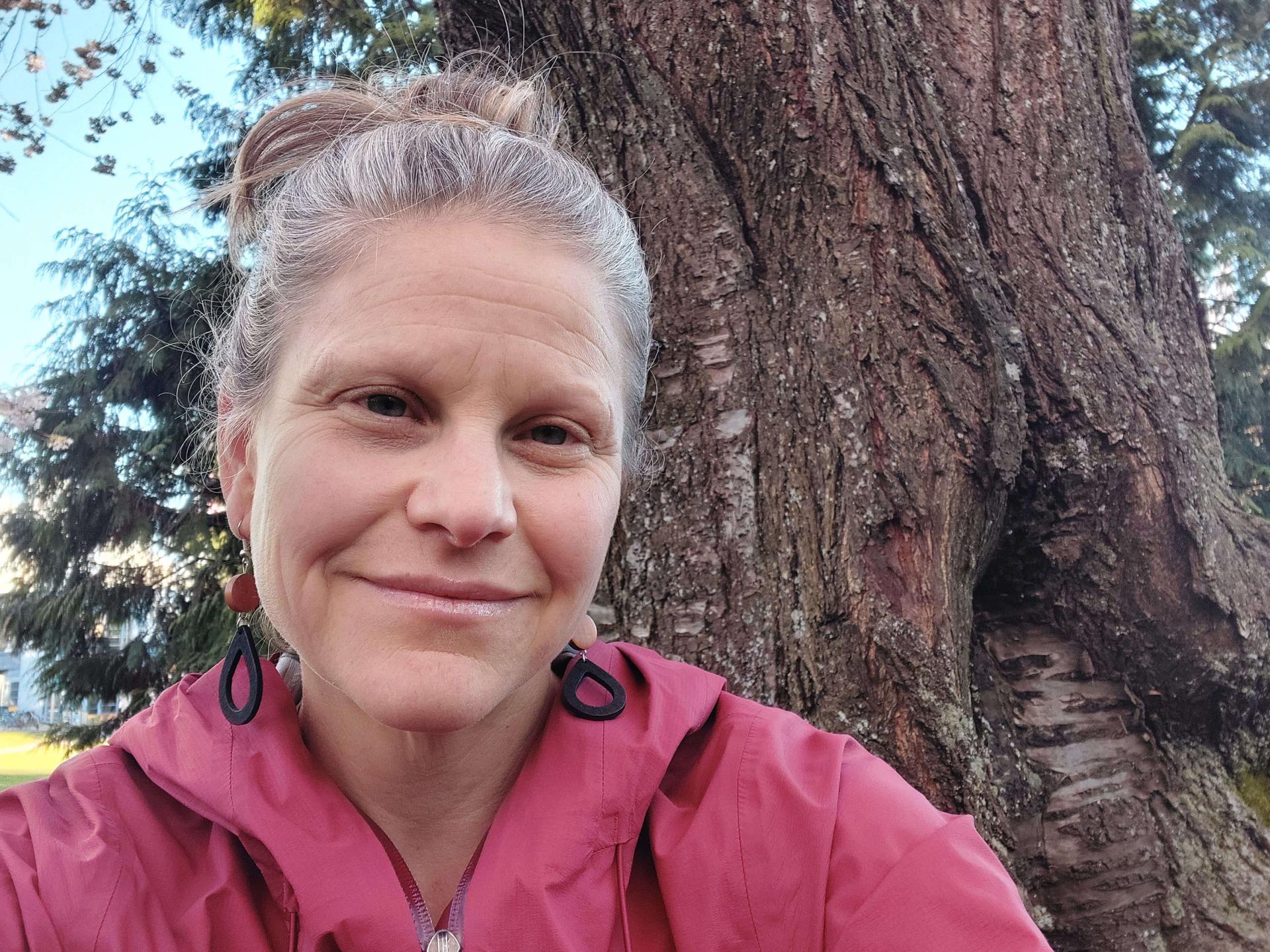 Rachelle Gould smiles in front of a large tree