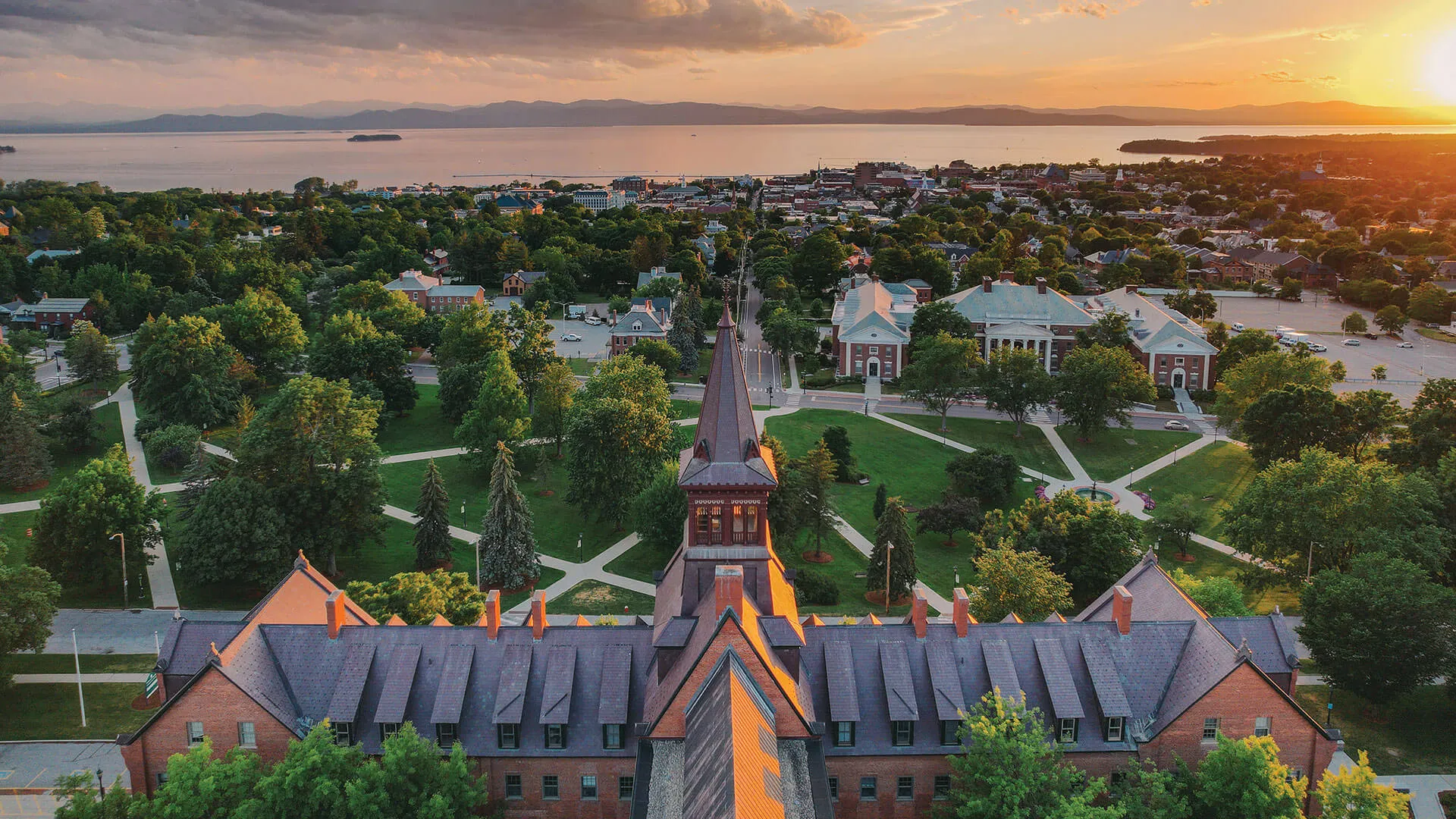 drone shot of old mill with burlington and lake champlain in the background