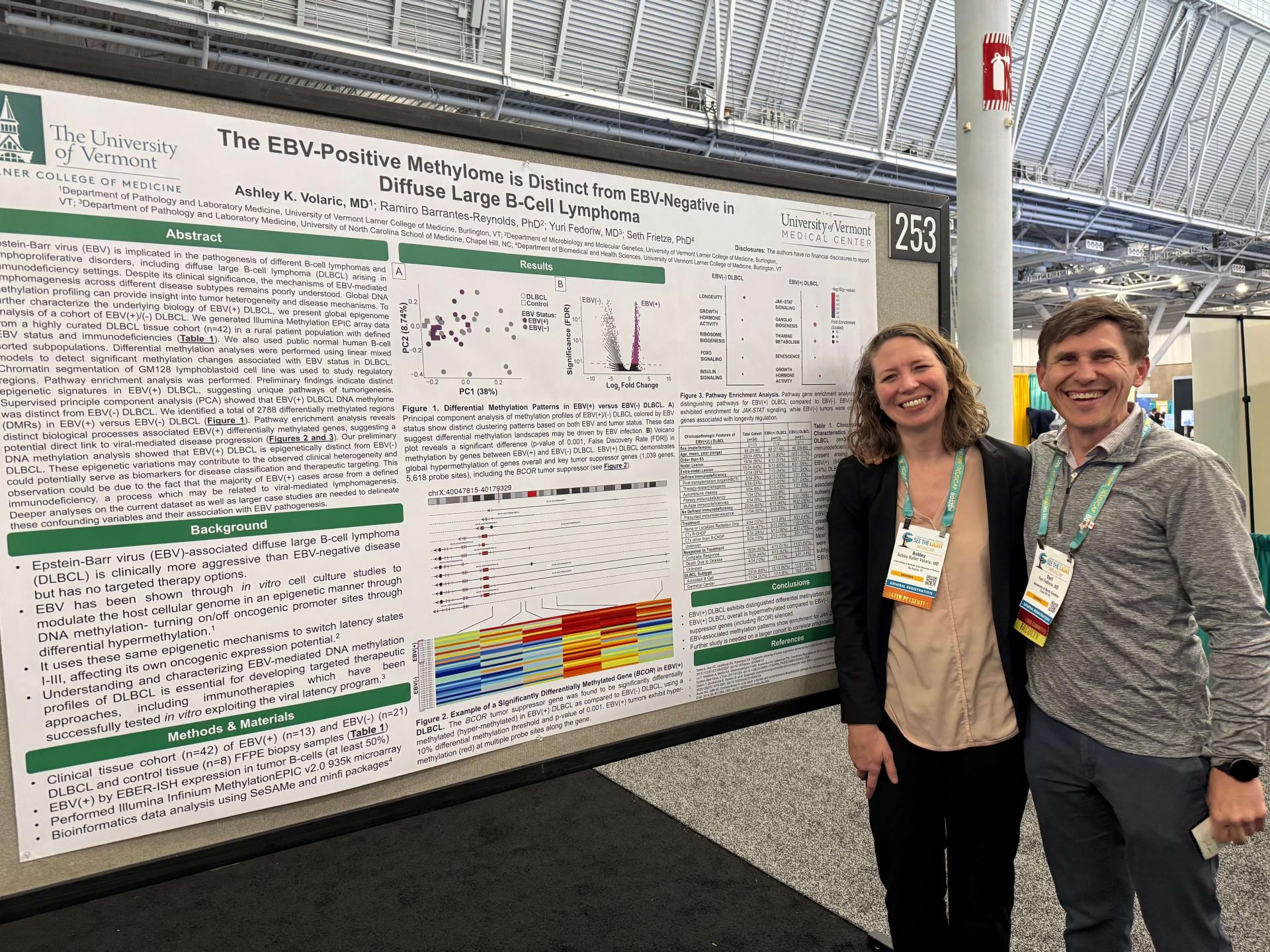 Ashley Volaric and conference attendee pose at poster session