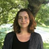 Student standing in front of the tree