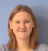 A woman with red hair and a grey shirt