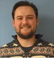 A man wearing a white and black sweater