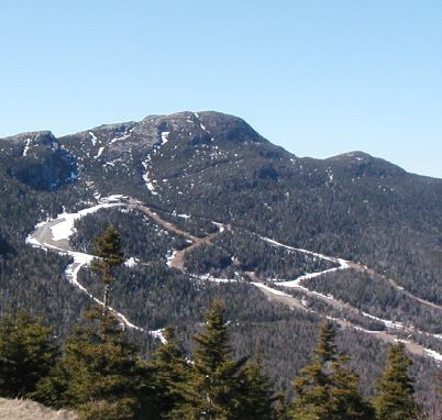 View of Mt. Mansfield ski trails with winter snow receeding.