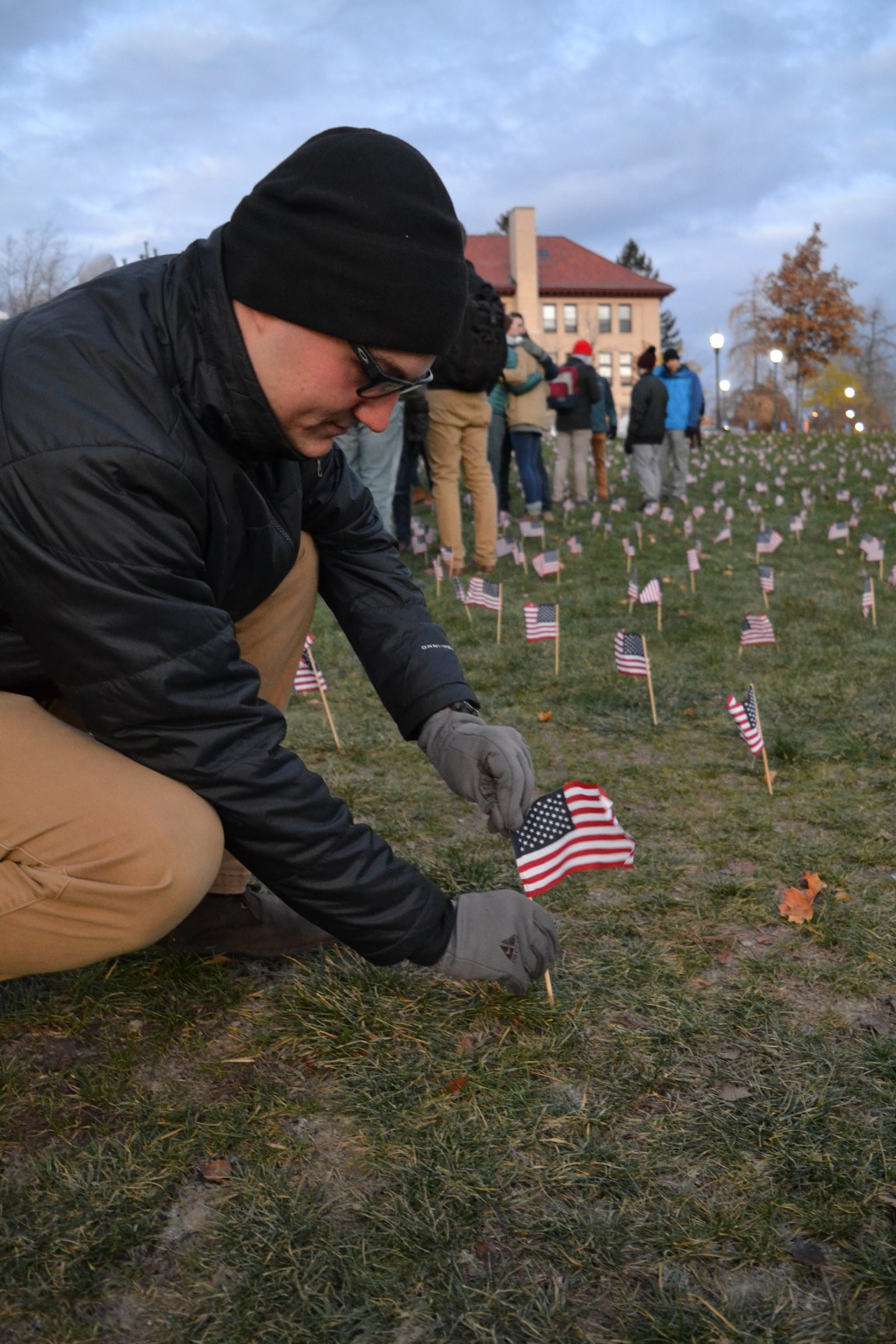Cadet Smetank plants flags to honor the fallen.