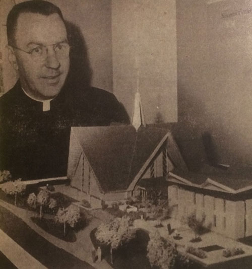 Photo of Father Branon with a model of the proposed Catholic center