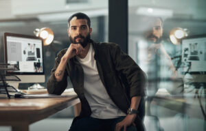 Portrait of a confident young businessman working late at night in a modern office.